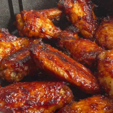 Crispy air fryer soy garlic wings garnished with green onions.