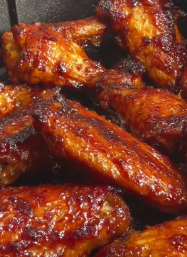 Crispy air fryer soy garlic wings garnished with green onions.