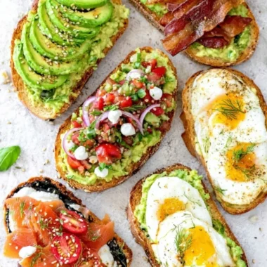 Delicious plate of avocado toast topped with tomatoes and herbs
