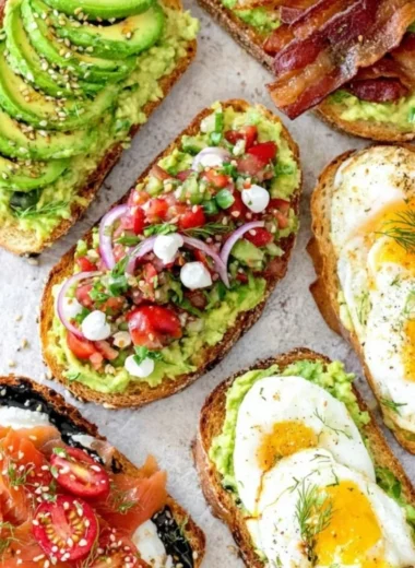Delicious plate of avocado toast topped with tomatoes and herbs
