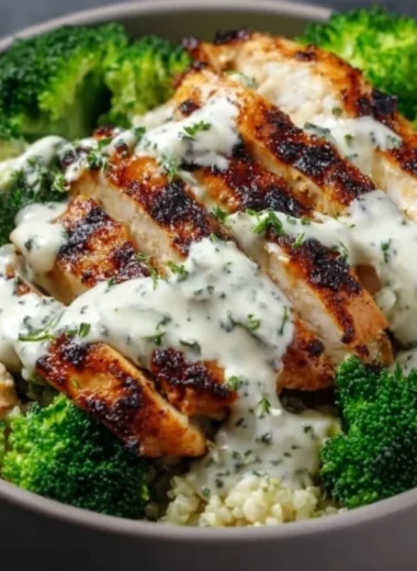 Healthy grilled chicken broccoli bowl with creamy garlic sauce