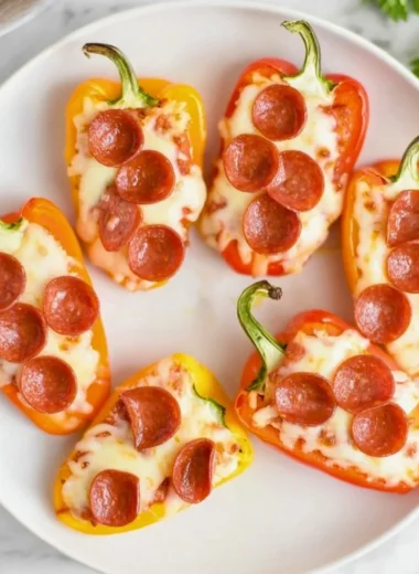 Pizza stuffed mini peppers filled with cheese and pepperoni on a plate