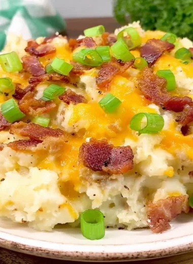 Delicious twice baked potato casserole topped with cheese and herbs.