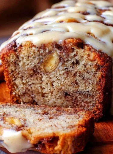 Freshly baked cinnamon roll banana bread with cinnamon swirl and glaze