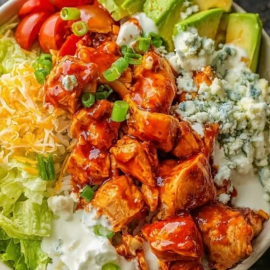 Delicious Buffalo Chicken Bowls filled with spicy chicken, vegetables, and creamy sauce.