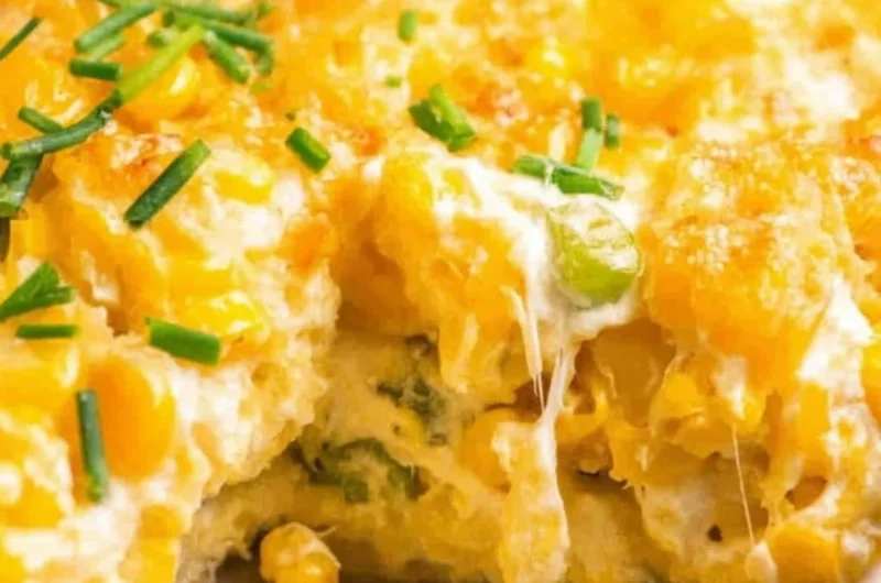 Deliciously creamy cream cheese corn casserole served hot in a baking dish.