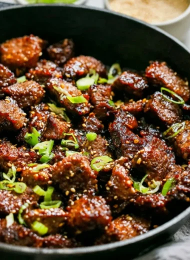 Easy Korean steak bites served on a plate with dipping sauce and garnishes.