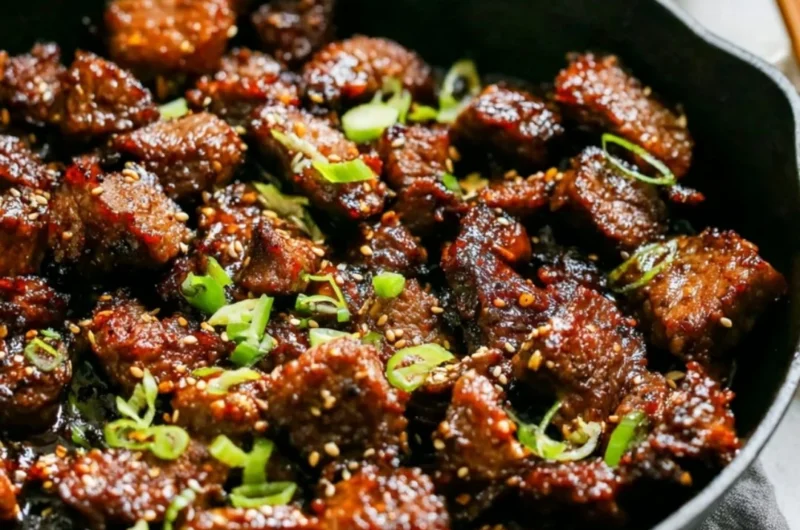 Easy Korean steak bites served on a plate with dipping sauce and garnishes.