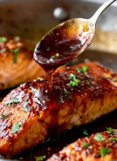Delicious honey garlic salmon garnished with herbs on a plate