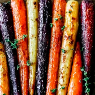 Plate of honey roasted colorful carrots garnished with fresh herbs
