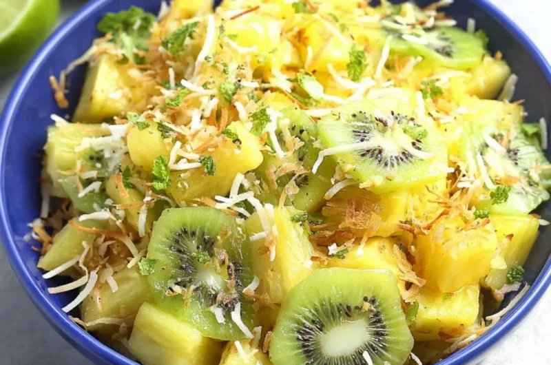 Fresh and colorful Pineapple Kiwi Salad in a bowl with mint leaves