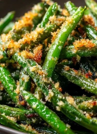 Roasted green beans with garlic and parmesan served on a plate