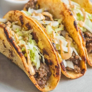 Delicious Smash Burger Tacos with beef patty and fresh toppings in a tortilla