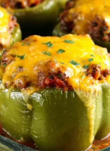 Colorful stuffed peppers filled with rice, vegetables, and spices.