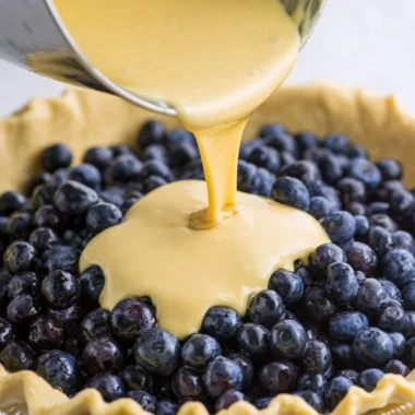 Delicious slice of Blueberries and Cream Pie with fresh blueberries on top