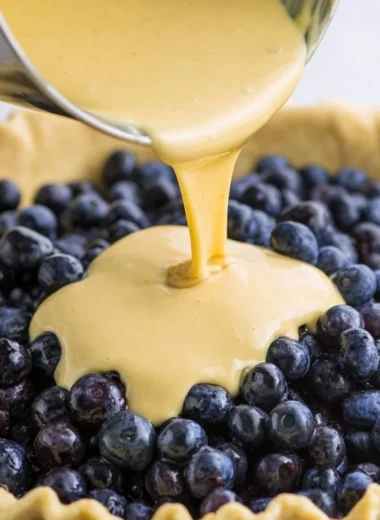 Delicious slice of Blueberries and Cream Pie with fresh blueberries on top