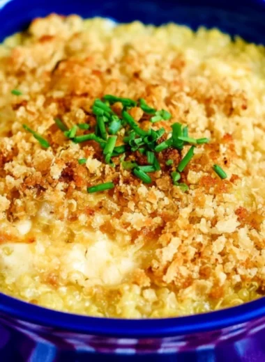 Cheesy quinoa mac and cheese topped with herbs in a bowl