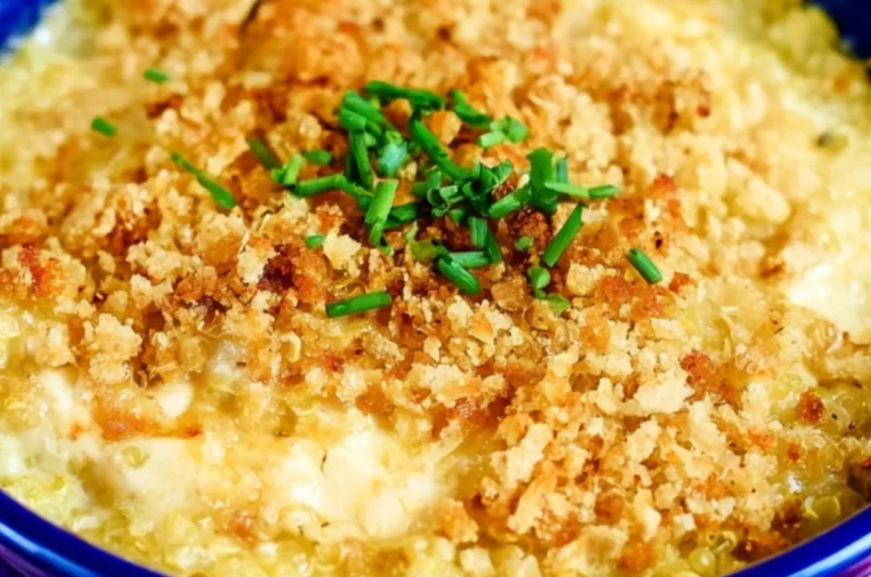 Cheesy quinoa mac and cheese topped with herbs in a bowl