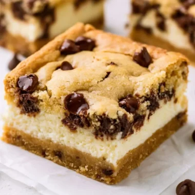 Delicious chocolate chip cheesecake bars on a white plate