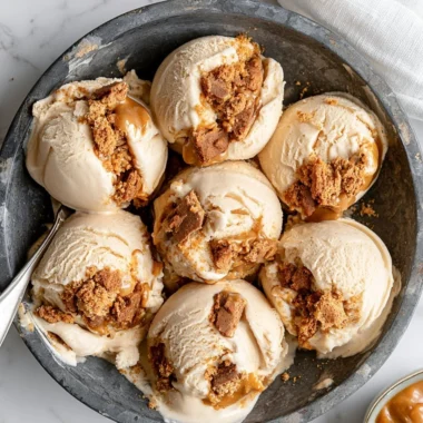 Delicious cookie butter ice cream topped with caramel drizzle and cookie crumbles.