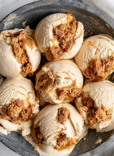 Delicious cookie butter ice cream topped with caramel drizzle and cookie crumbles.