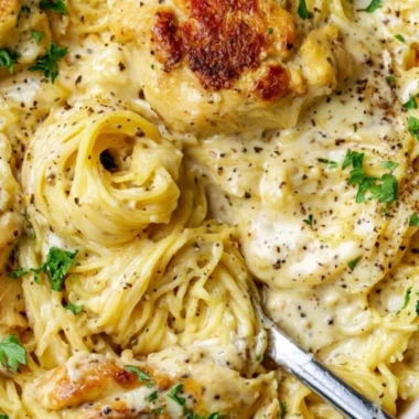 Delicious Crock Pot Angel Chicken served on a plate with herbs.