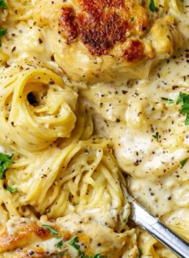 Delicious Crock Pot Angel Chicken served on a plate with herbs.