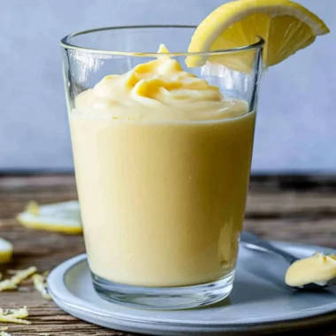 Delicious lemon cream dessert topped with zest and fresh lemon slices