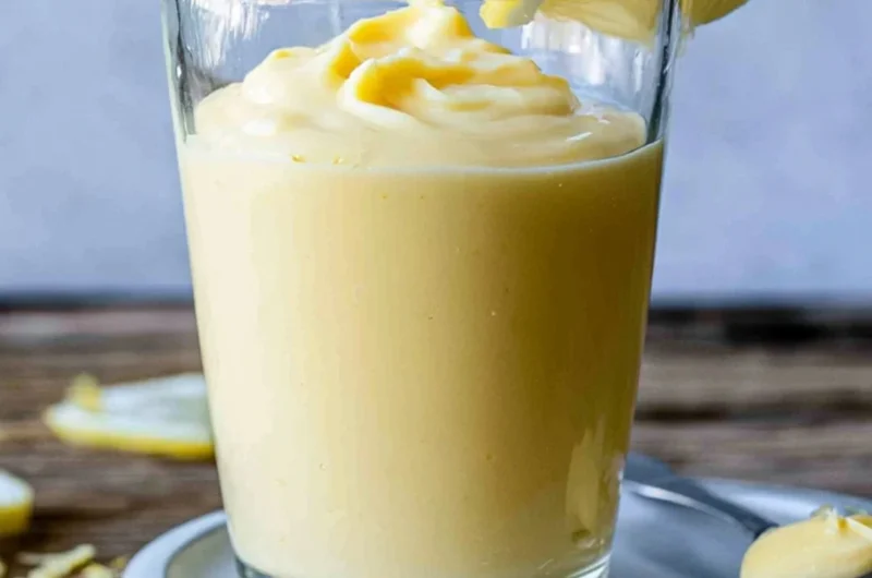 Delicious lemon cream dessert topped with zest and fresh lemon slices
