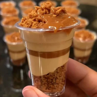 Mini Biscoff cheesecake cups topped with crushed Biscoff cookies