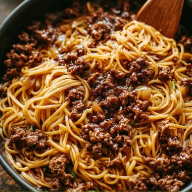 Plate of Mongolian ground beef noodles garnished with green onions