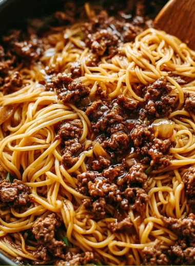 Plate of Mongolian ground beef noodles garnished with green onions