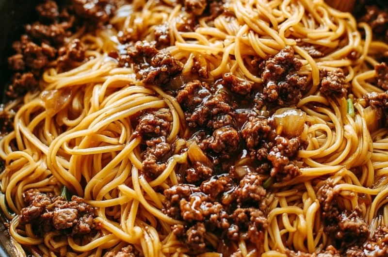 Plate of Mongolian ground beef noodles garnished with green onions