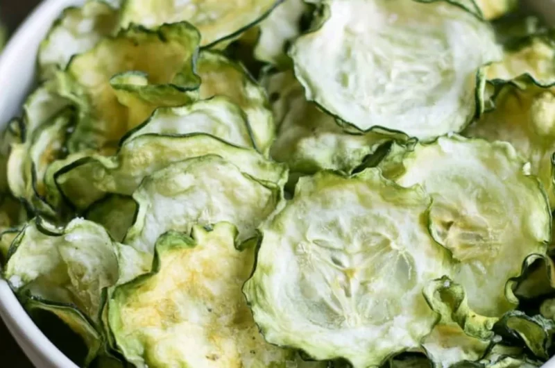 Salt and vinegar cucumber chips served in a bowl, a healthy snack alternative.