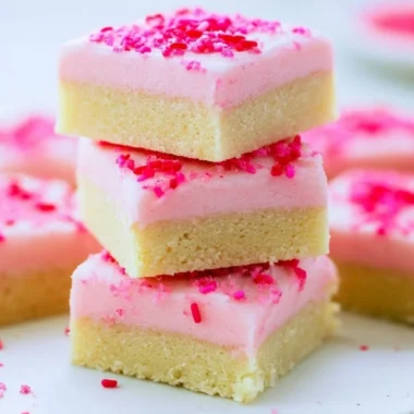 Delicious sugar cookie bars topped with colorful frosting and sprinkles