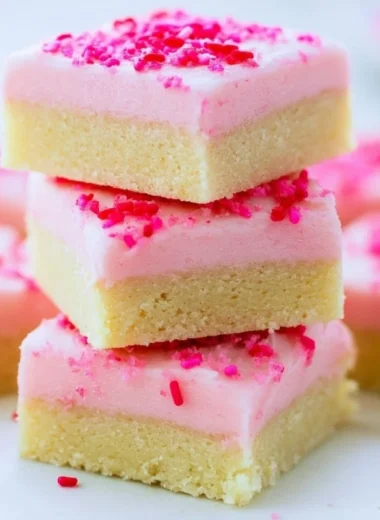 Delicious sugar cookie bars topped with colorful frosting and sprinkles