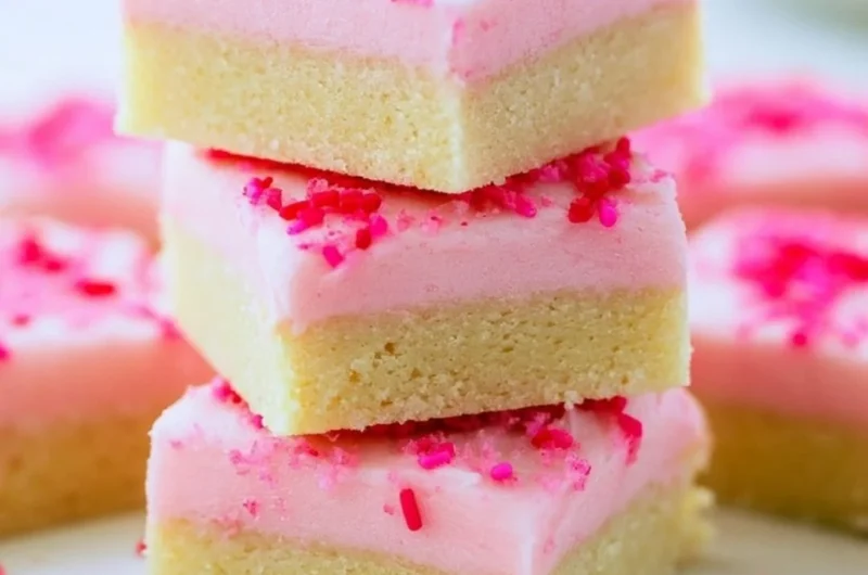 Delicious sugar cookie bars topped with colorful frosting and sprinkles