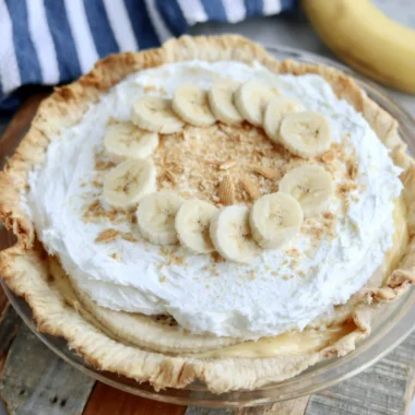 Delicious homemade Banana Cream Pie topped with whipped cream and sliced bananas.