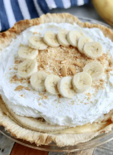 Delicious homemade Banana Cream Pie topped with whipped cream and sliced bananas.