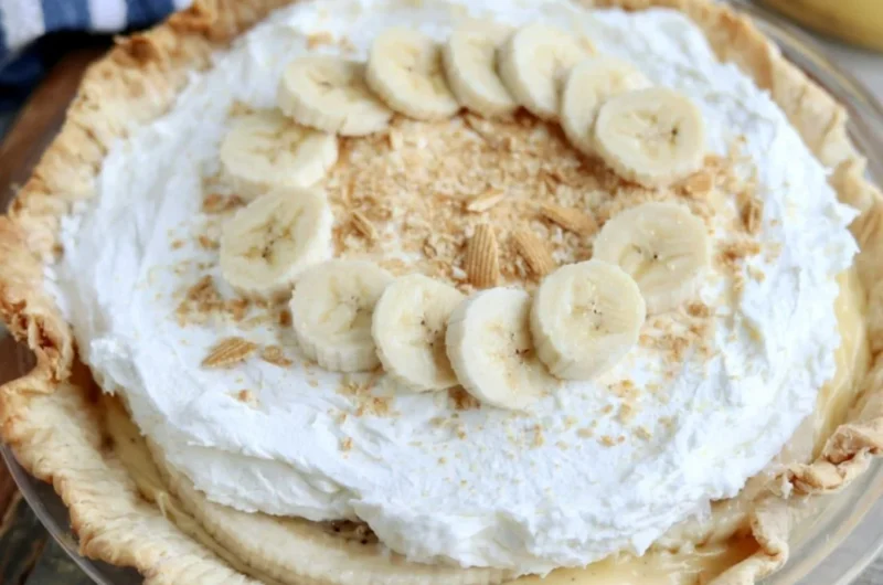 Delicious homemade Banana Cream Pie topped with whipped cream and sliced bananas.