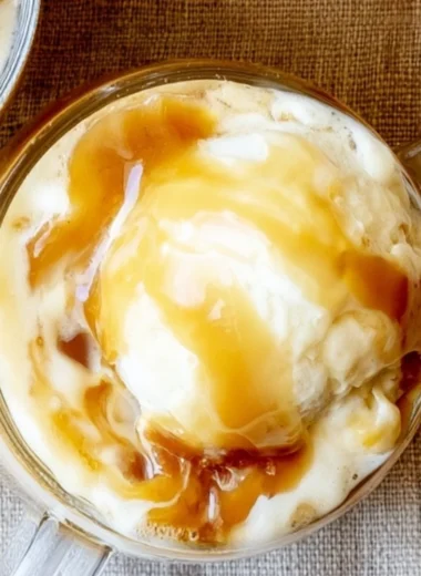 Delicious caramel apple cider float topped with whipped cream