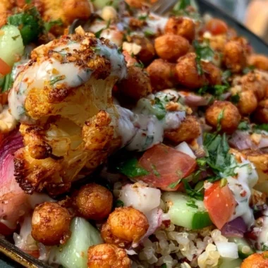 Delicious Cauliflower Shawarma Bowl topped with fresh vegetables and tahini sauce