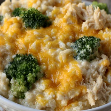 Cheesy broccoli chicken and rice casserole topped with melted cheese.