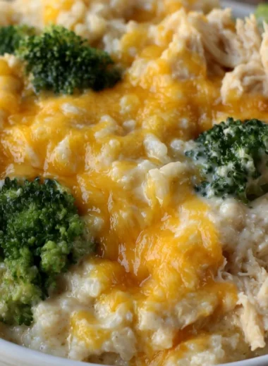Cheesy broccoli chicken and rice casserole topped with melted cheese.