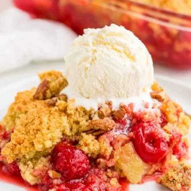 Delicious cherry dump cake served in a dish with cherries on top