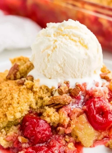 Delicious cherry dump cake served in a dish with cherries on top