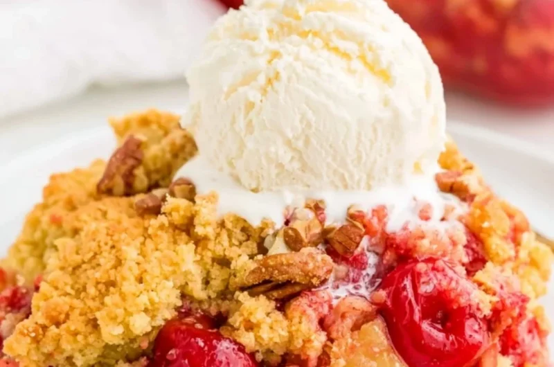 Delicious cherry dump cake served in a dish with cherries on top