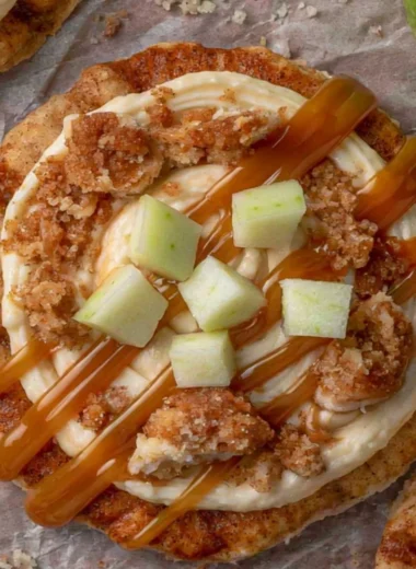 Delicious Crumbl Caramel Apple Cookies with caramel drizzle and apple chunks