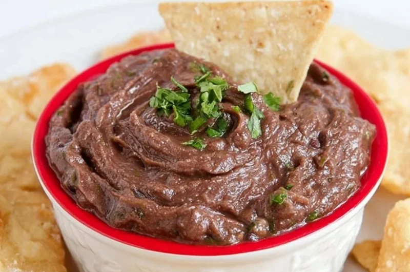 Easy Vegan 5-Minute Black Bean Dip served in a bowl with fresh herbs