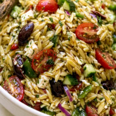 Colorful Greek Orzo Salad with fresh vegetables and feta cheese